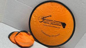 lot 7779 image: Genuine Country Music Association Collapsible Frisbee-2 pack