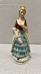 lot 7792 image: Porcelain Figurine Woman Red Dress Yellow Skirt