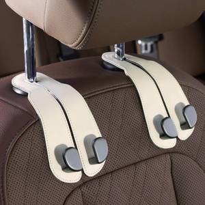 lot 760 image: CoBak Headrest Hooks for Car - Universal Premium Stitched Leather and Aluminum-Magnesium Alloy Double Car Seat Back Storage Hook for Purses, Handbags, Bags (2 Pack),Beige - Retail $10