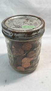 lot 17 image: 16 OZ Mason Jar with Metal Lid full of change