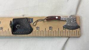 lot 92 image: Small Axe Keychain with Patterned Head and Wood Handle