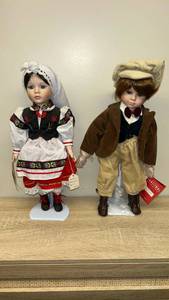 lot 5 image: Pair of Porcelain Dolls with Cultural Costumes and Stands