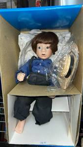 lot 42 image: Amish Doll with Brown Hair Blue Shirt Black Pants
