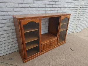 lot 8 image: Rolling Wood Display Cabinet with Glass Doors and Lower Storage Compartments 80 x 52 x 16