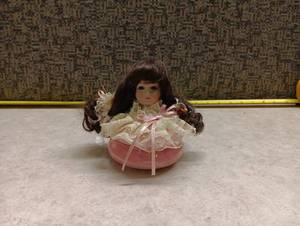 lot 585 image: Doll with Pink Base and Lace Collar Approximately 3.5 Inches