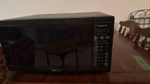 lot 909 image: Panasonic microwave oven with turn table located in basement