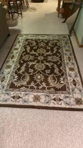 lot 910 image: At Home area rug approx 5 ft x 7 ft located in basement