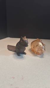 lot 1002 image: Cast iron squirrel door stop 4 inches tall, marigold glass piggy bank