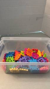 lot 1122 image: Colorful Interlocking Plastic Building Blocks Lot in Clear Storage Container