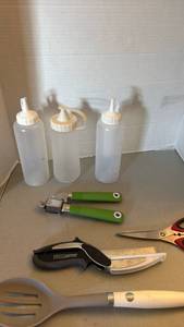 lot 1218 image: Kitchen Tool Lot Squeeze Bottles, Garlic Press, Clever Cutter, Spatula, Scissors