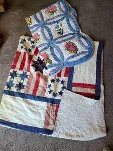 lot 1441 image: Floral quilted throw blanket and a stars and stripes quilt with stains and a small tear