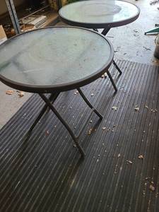 lot 3050 image: Pair of round folding glass top patio tables, 18 x 19in tall
