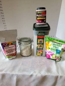 lot 3060 image: Jar of broken eggshells, orchid food, all-purpose plant food.