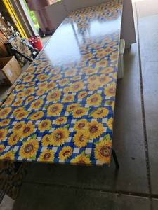 lot 3103 image: One 8ft folding table with vinyl sunflower covering