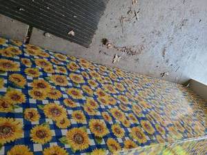 lot 3104 image: One additional 8ft folding table with vinyl sunflower covering