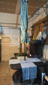 lot 3302 image: Patio Umbrella, Umbrella Holder, Outdoor Table 28x40x40 inches, and Blue Checkered Table Runners