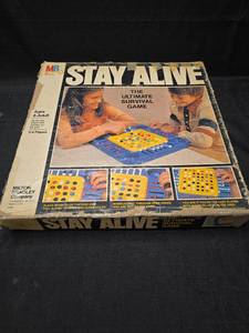 lot 2127 image: Milton Bradley Stay Alive The Ultimate Survival Game 2-4 Players Ages 8