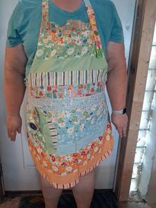 lot 132 image: Patchwork Apron with Floral Fabric Strips and Decorative Buttons