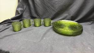lot 130 image: Green Glass Dinnerware Set. Place setting of 4