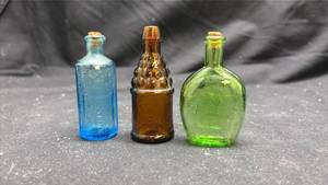 lot 185 image: 3 Embossed Glass Bottles Blue Brown Green Small Vintage