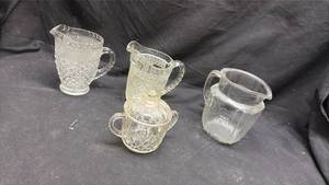 lot 208 image: 4-Piece Glass Pitcher and Creamer Set with Lids Cut and Pressed Pattern