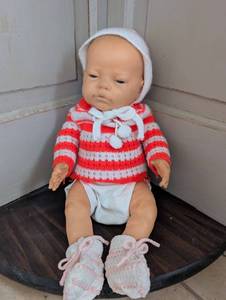 lot 5501 image: Baby Doll with Red and White Striped Sweater, Bonnet and Booties
