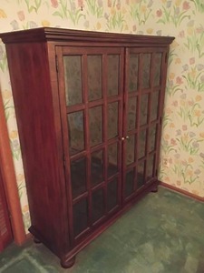lot 1003 image: Wooden Storage Cabinet with Glass Doors.  62 x 53 x 18.  Glass is beveled.