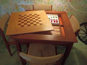 lot 1005 image: Game Table with 4 Chairs.   Chess, Checkers and Backgammon.   Comes with Chess Pieces.  Top needs repaired.  30 x 36 x 36