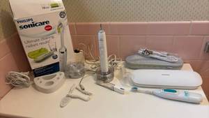 lot 1401 image: Philips Sonicare Electric Toothbrush with UV Sanitizer Case and Accessories.