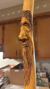 lot 1804 image: Wood Walking Stick with Carved Face Figure 6ft