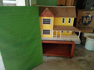 lot 2000 image: Childs Doll House with table and platform.   Dollhouse needs repaired.   Dollhouse 48 x 41 x 21.5.  Table 18 x 31.5 x 31.5.  And Platform 49 x 30.5.  Both table and platform are on wheels