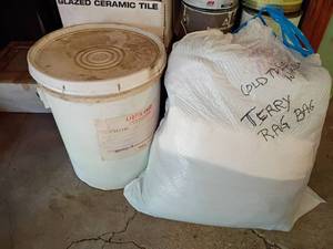 lot 2001 image: Bag of Rags with a Dirty Rag Bucket.  Appears to be a lot of old towels