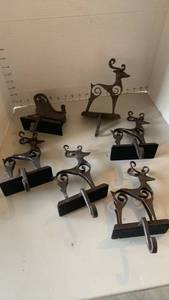 lot 1532 image: 8 cast iron stocking hangers with Scrolled Details