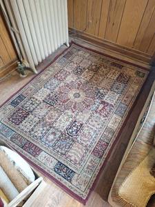 lot 9 image: Clean Area Rug with Red Border and Geometric Pattern