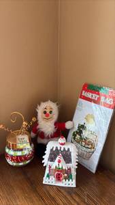 lot 74 image: Holiday Christmas Decoration Lot Santa Figure, Light Up Gingerbread House, Basket Cello Bag