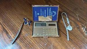 lot 76 image: Solar Power Calculator and Business Card Holder with Musical Theme and Two Metal Bookmarks
