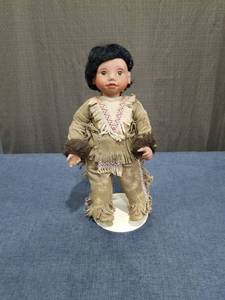 lot 2468 image: Doll with Black Hair and Fringed Tan Outfit