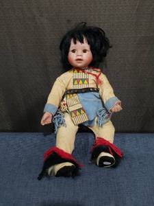 lot 2469 image: Doll with Black Hair Cream and Blue Outfit Native American Style Clothing