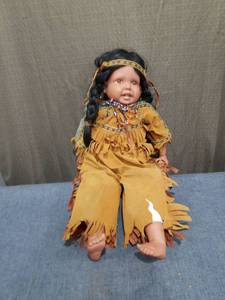 lot 2472 image: Doll with Black Hair and Native American-Style Tan Outfit