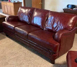 lot 900 image: Burgundy leather 3 seat sofa 36 x 84 x 36 in (located in the basement)
