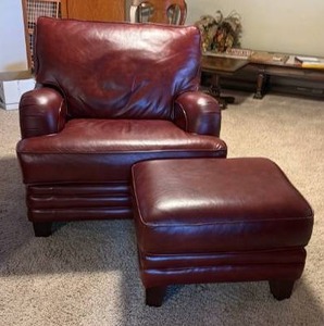 lot 902 image: Burgundy leather arm chair 36 x 38 x 36 in with ottoman 18 x 26 x 20 in (located in basement)