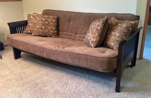 lot 903 image: Wood framed futon 33 x 82 x 38 in when up in couch position. Opens into a full size mattress (located in basement)