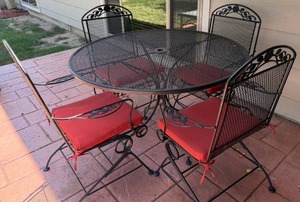 lot 920 image: Wrought iron patio table 30 x 42 x 42 in with 4 matching rocker chairs and cushions