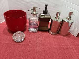 lot 1222 image: Soap and lotion dispensers, glass flower frog, red ceramic flower pot.