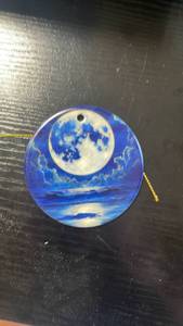 lot 33245 image: Round Full Moon Painted Ornament with Gold Cord - Retail $12