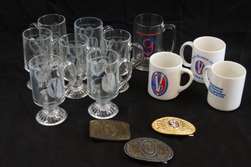 lot 312 image: Lot of 95th Infantry Division, IT & TNG (training) Belt Buckles, Mugs & Glasses