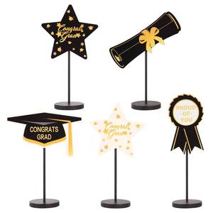 lot 2284 image: 2026 Graduation Decorations, 5Pcs Black Gold White Wooden Table Centerpieces Decor Include Grad Cap Diploma Star Supplies Medal Sign, of Congrats Graduation Day Class Party Decoration.