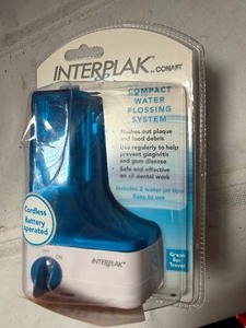 lot 25917 image: New Conair Interplak Compact Water Flossing System