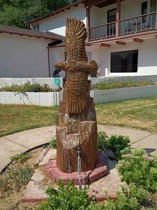 lot 891 image: Hand Carved Flying Eagle.  Approximately 7ft. tall x 3ftWill need to bring help.  Man power and machine.   Very Heavy