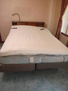 lot 900 image: Queen Sized Adjustable Bed, Easy Rest with Massage. Has extra foam piece on top.  Small stain.  Headboard 41 x 56.5 x 8.5.  Located upstairs